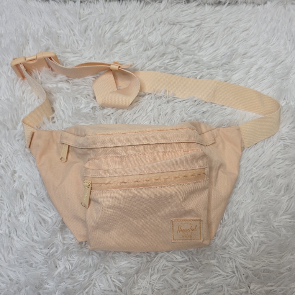 Herschel Seventeen hip pack in a light peach color.